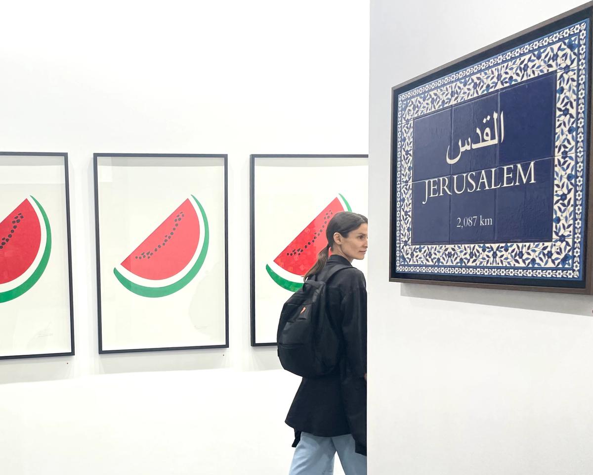 A visitor to the stand of Zawyeh gallery, based in Ramallah and Dubai, at the 17th edition of Art Dubai