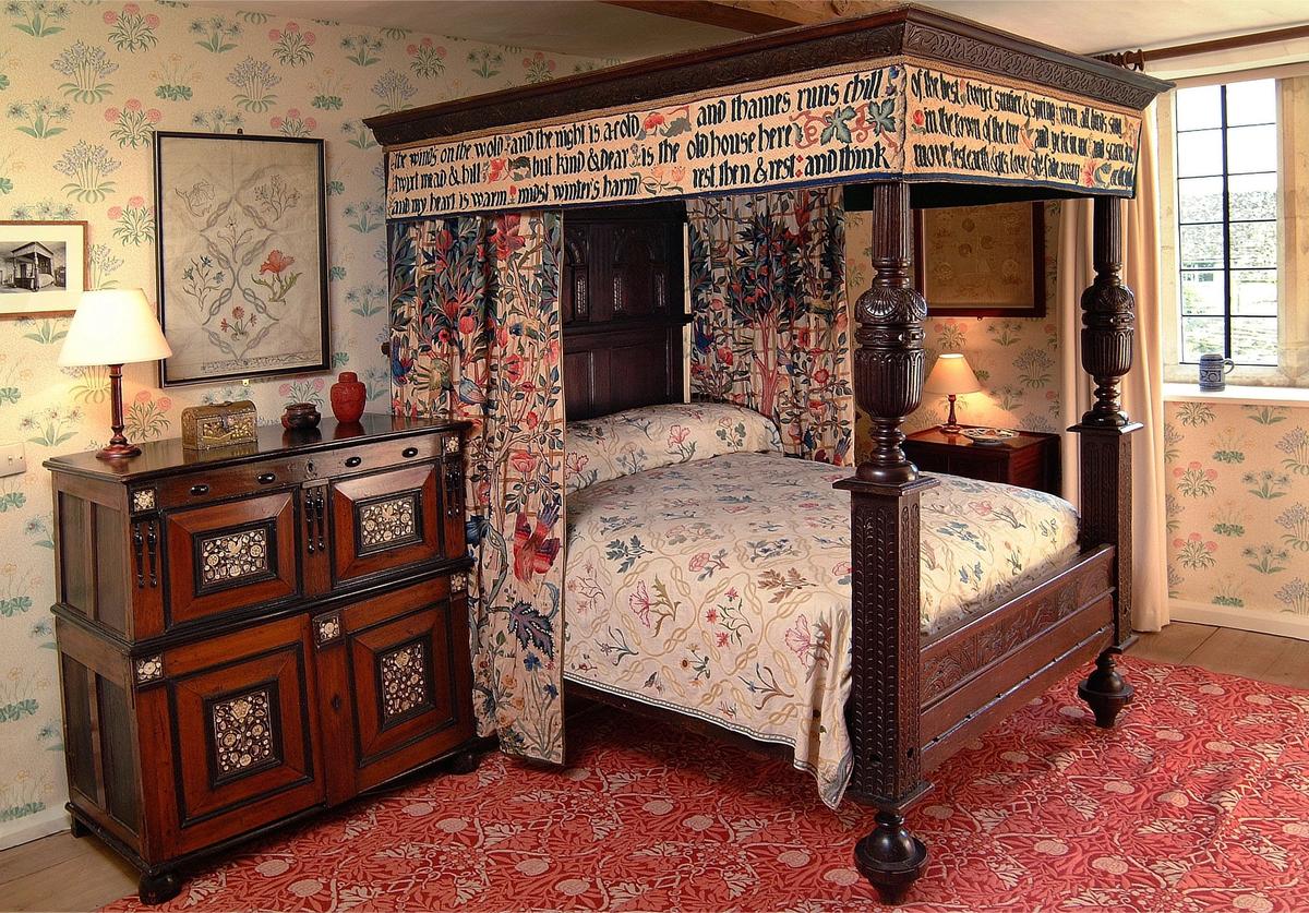 William Morris’s four-poster bed made up of carved  Elizabethan and Jacobean oak woodwork. It is the bed for which Morris wrote the poem For the bed at Kelmscott and in  which he slept on his visits to the house © Society of Antiquaries