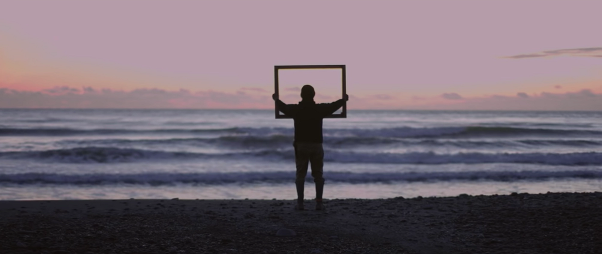 A still from Joe Biden and Kamala Harris's video showing diverse Americans holding up a golden frame, which was inspired by Lorraine O’Grady's 1983 performance Art Is…