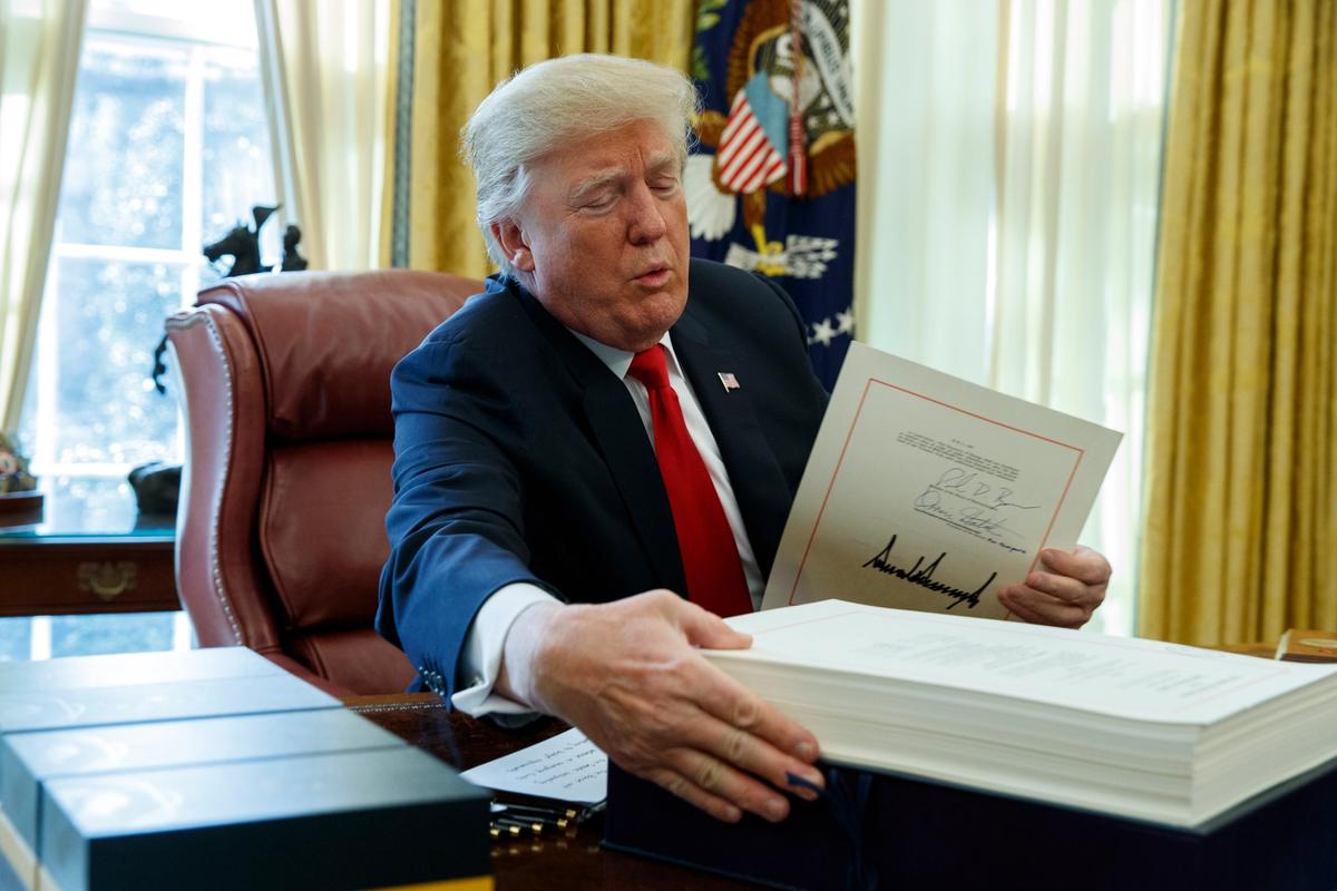 US President Donald Trump signs the tax bill AP Photo/Evan Vucci