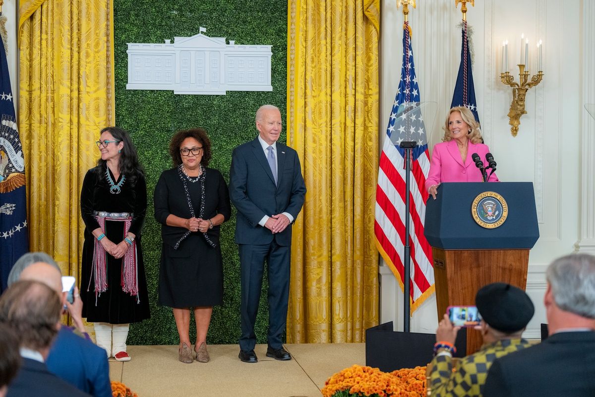 US First Lady Jill Biden speaks during a reception for the National Medal of Arts honourees at the White House on 21 October, while, from left to right, Chair of the National Endowment for the Humanities Shelly C. Lowe, Chair of the National Endowment for the Arts Maria Rosario Jackson and US President Joe Biden look on Photo courtesy the White House