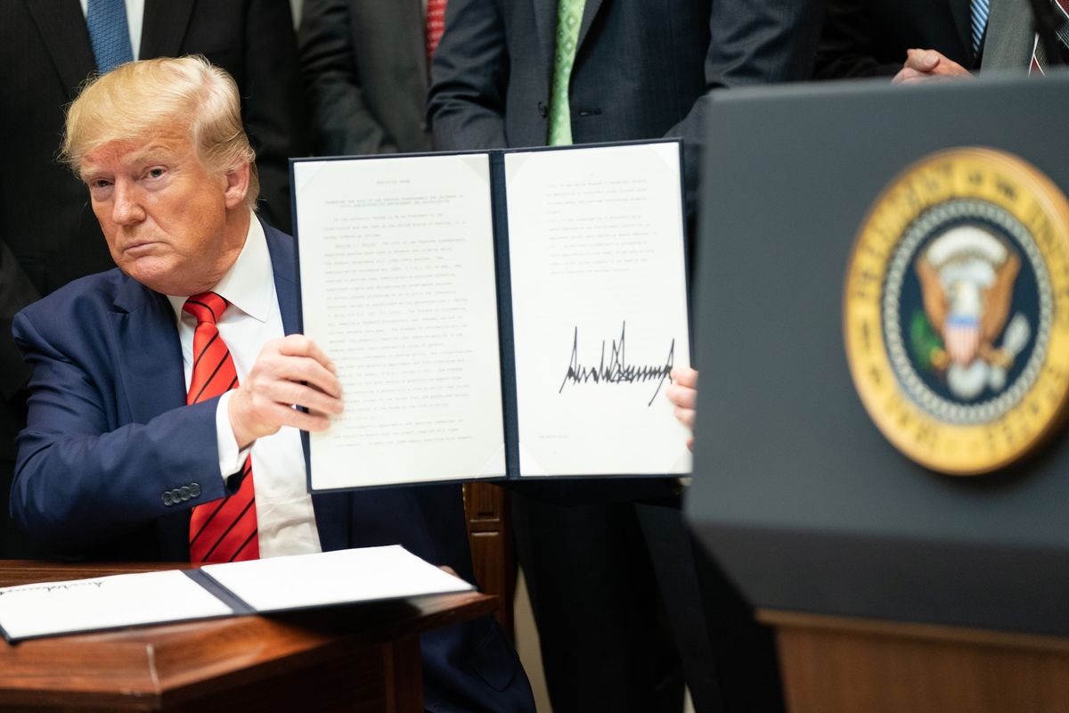 US President Donald Trump signing an executive order during his first term in 2019 Official White House Photo by Shealah Craighead, via Flickr