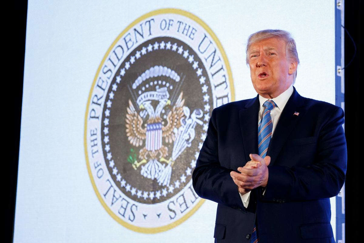 President Donald Trump arrives to speak, with an altered presidential seal behind him, at Turning Point USA's Teen Student Action Summit 2019 AP Photo/Alex Brandon