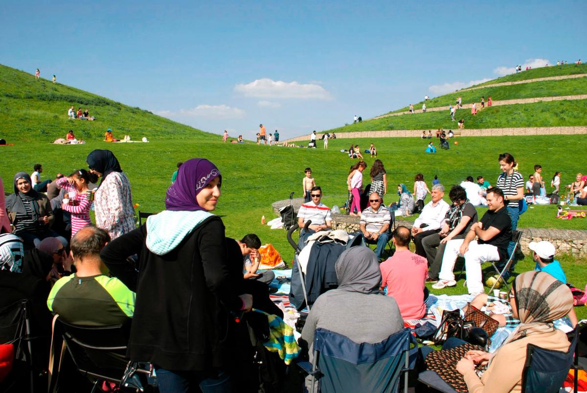 Crowds gather at Northala Fields, which is a public park featuring four manmade conical mounds 
Courtesy of Studio Fink
