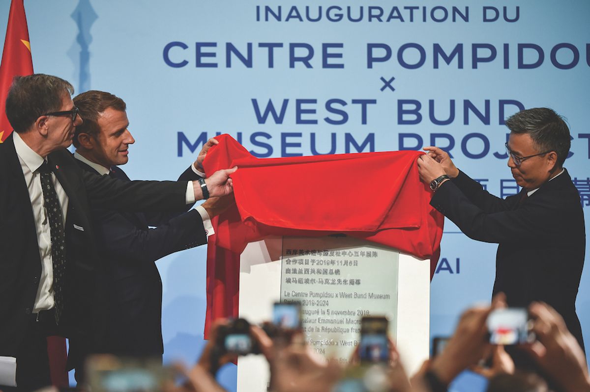 Serge Lasvignes, Emmanuel Macron and West Bund chairman Fong Shizhong at the inauguration of the Centre Pompidou West Bund Hector Retamal/Pool via Reuters