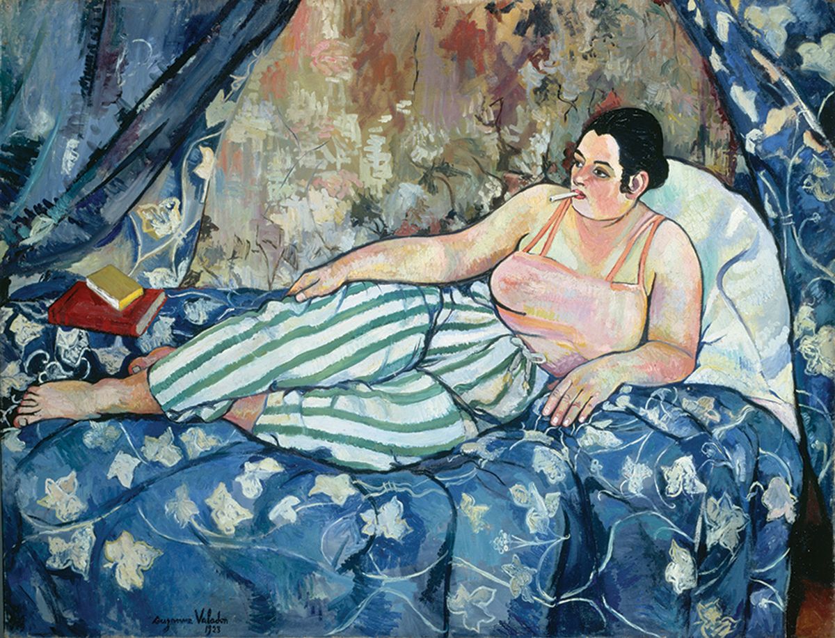 In The Blue Room (1923), Valadon replaces the traditional female nude with a woman wearing stripey trousers, a cigarette hanging from her mouth Photo: Jacqueline Hyde; © Collection Centre Pompidou; © 2021 ARS, New York/Image © CNAC/MNAM; Dist. RMN-Grand Palais/Art Resource, NY