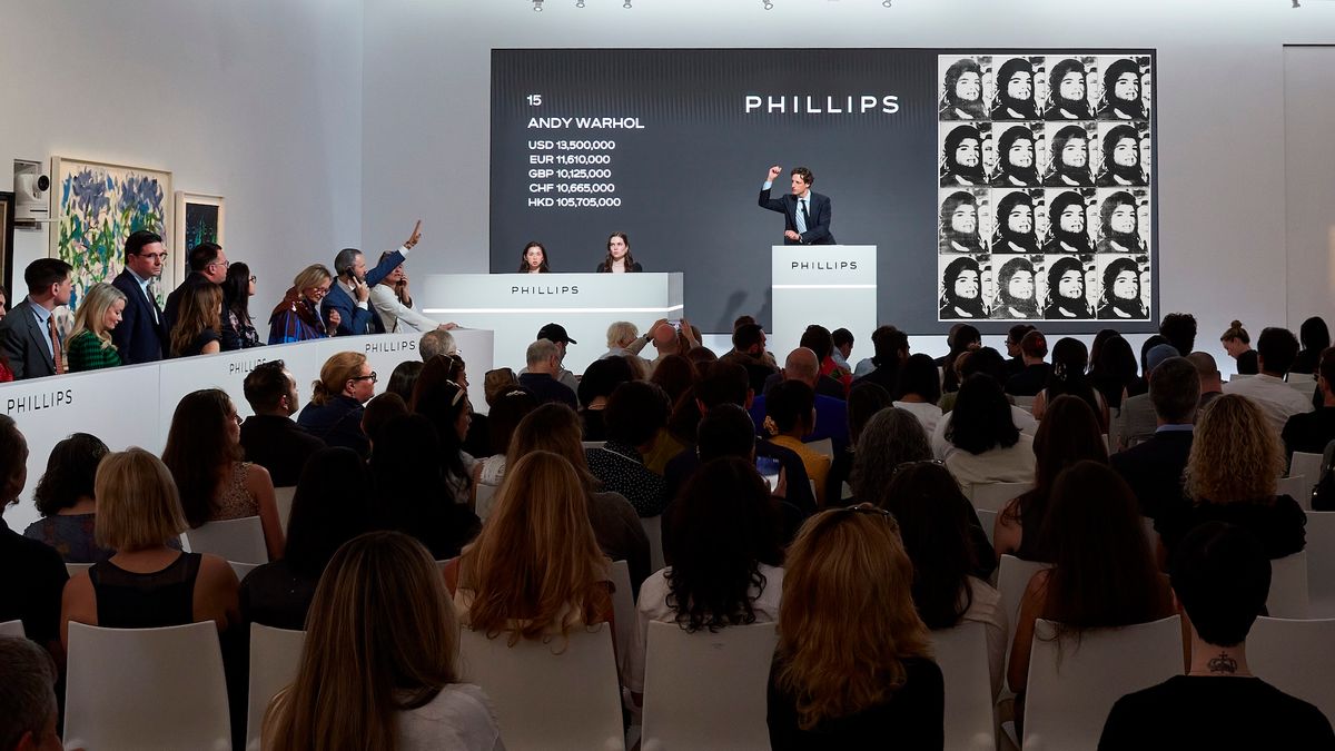 Phillips auctioneer Henry Highley fields bids for Andy Warhol's Sixteen Jackies, the top lot at the auction house's 19 May evening sale in New York Courtesy Phillips
