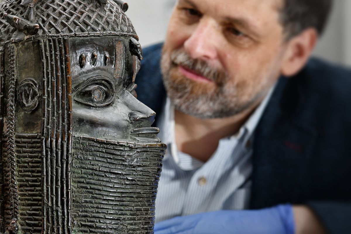 Neil Curtis, the head of museums and special collections at the University of Aberdeen, with the Benin sculpture Image: courtesy of University of Aberdeen