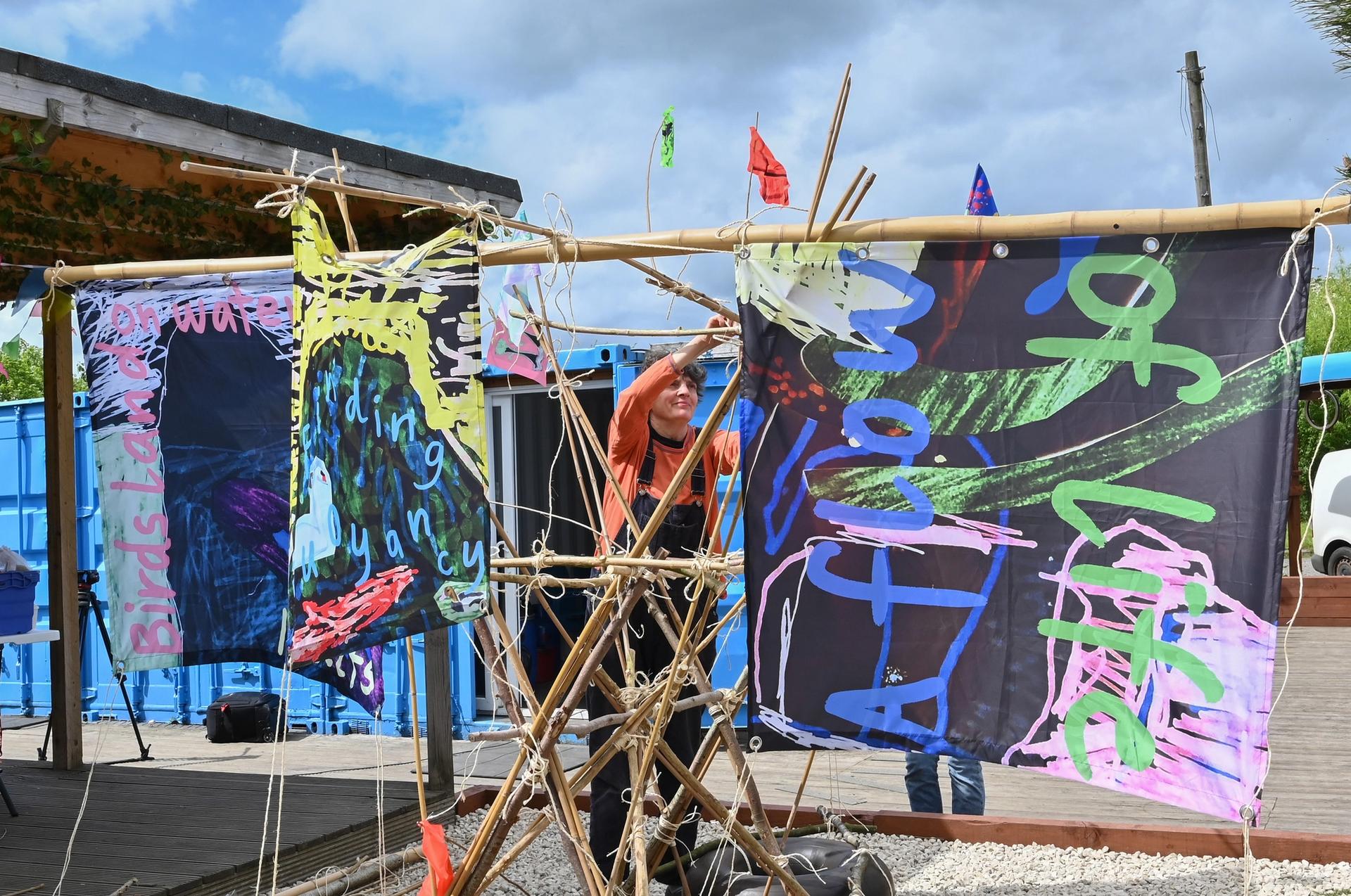 The artist Sarah Kenchington hanging sails by Peter and Rossi at Bridge 8 Hub, during Canal Connections, part of Edinburgh Art Festival 2022 Photo: Julie Howden