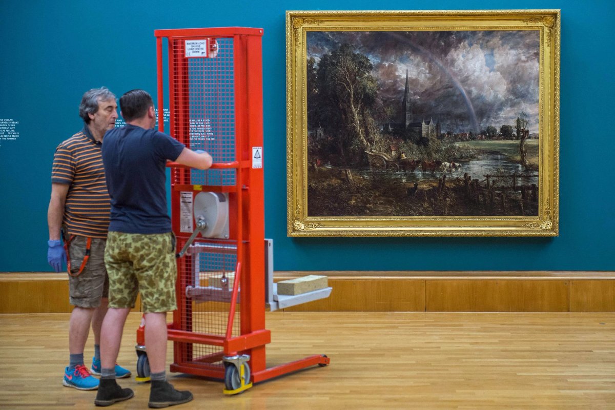 Workers install a Constable painting at Tate Britain. But according to the Convelio survey, job satisfaction among operations staff is low: around half were looking for a new job
Guy Bell/Alamy Stock Photo
