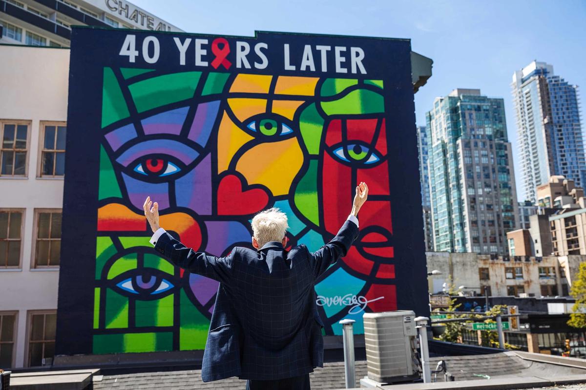 Joe Average in front of his new mural One World, One Hope—40 Years Later Photo: Mavreen David