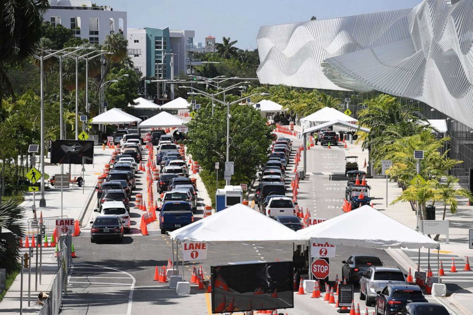 Cars wait in line at the coronavirus drive-in testing site, set up at the Miami Beach Convention Center in Miami Beach. Larry Marano/Shutterstock