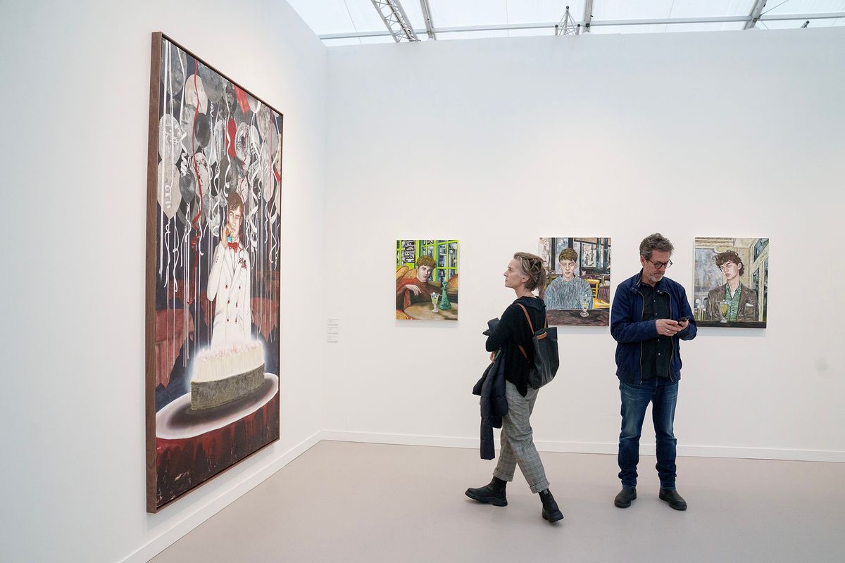 Visitors examine works by Hernan Bas at the 2024 edition of Frieze Los Angeles © Eric Thayer