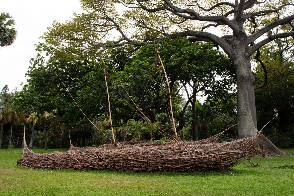 Leland Miyano's canoe sculpture made from invasive plants Huaka‘i / A Wake (2019) installed at the Foster Botanical Garden for the 2019 Honolulu Biennial Courtesy of the Honolulu Biennial Foundation. Photo by Christopher Rohrer