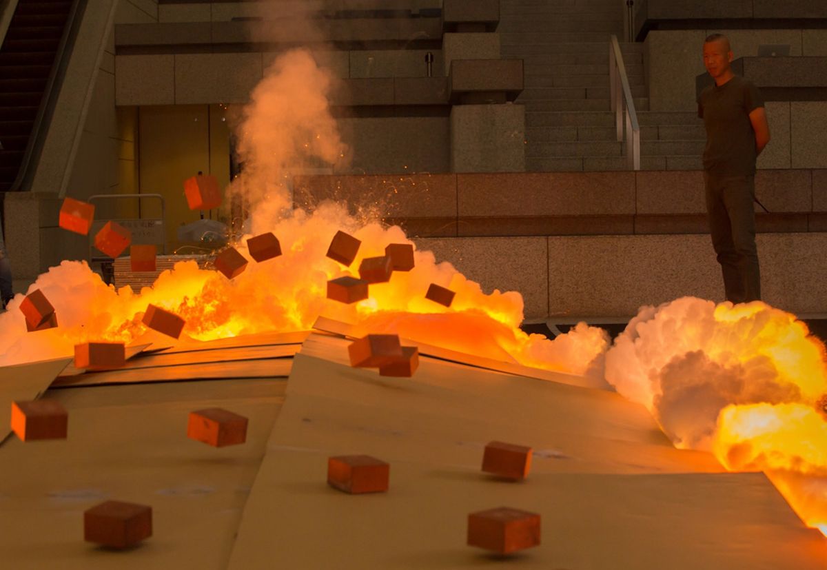 Cai Guo-Qiang igniting a gunpowder painting at the Yokohama Museum of Art, 2015 Photo by Kamiyama Yosuke, courtesy Cai Studio