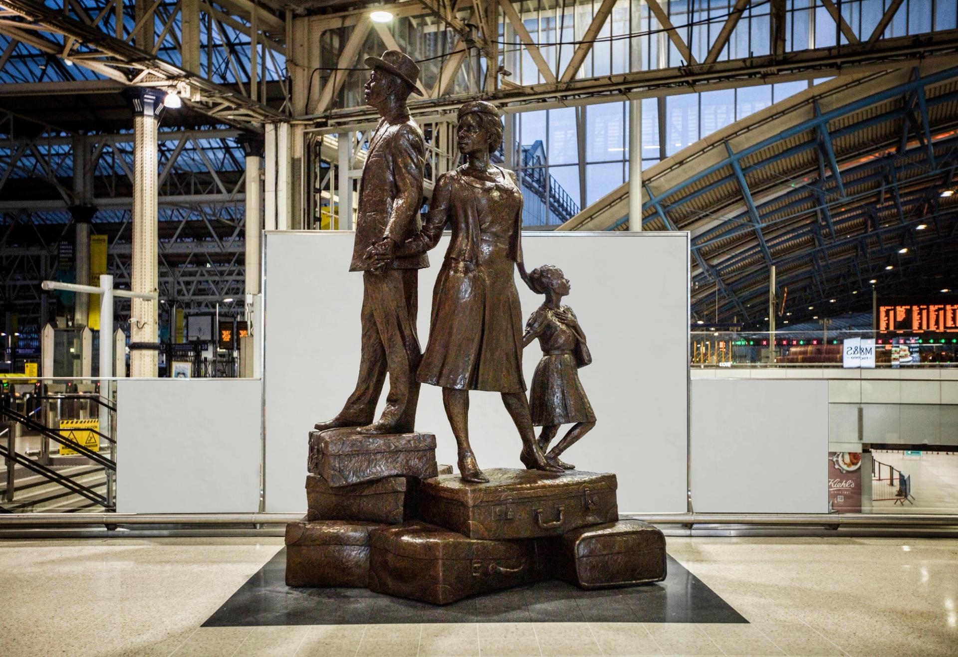 Basil Watson’s work at Waterloo station in London shows a man, woman and child climbing a mountain of suitcases, hand-in-hand Photo: © Steve Russell Studios