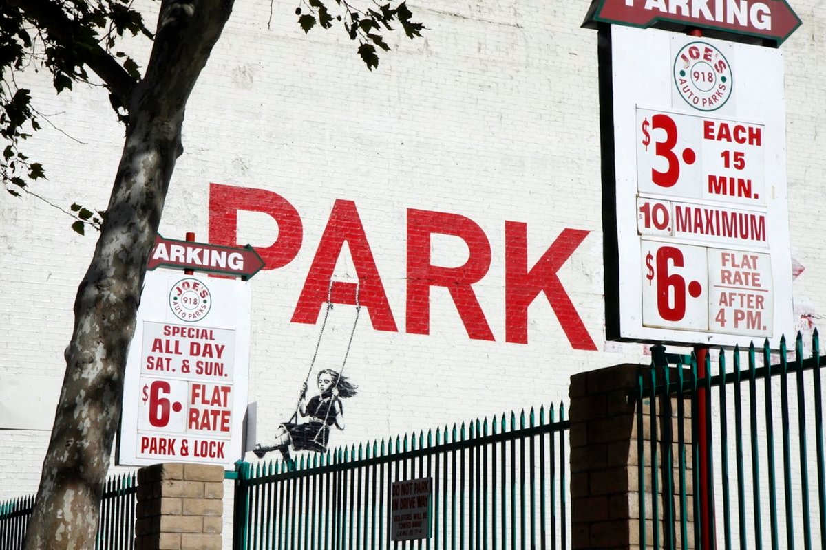 Banksy's mural known as "Swing Girl" or "Girl on a Swing" on the exterior of 908-910 South Broadway in downtown Los Angeles. Photo by jondoeforty1, via Flickr.