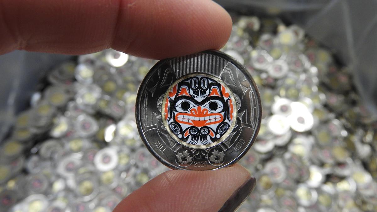 The Royal Canadian Mint is launching two versions of a new toonie commemorating Haida artist Bill Reid — one in red and black, and another uncoloured The Royal Canadian Mint