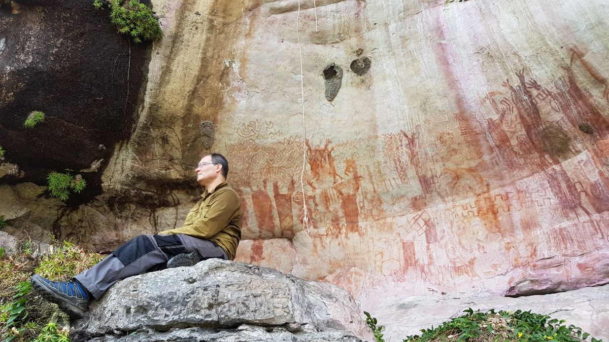 José Iriarte, professor of Archaeology at Exeter, at a rock art wall depicting mastadons in the Amazon rainforest Credit: José Iriarte