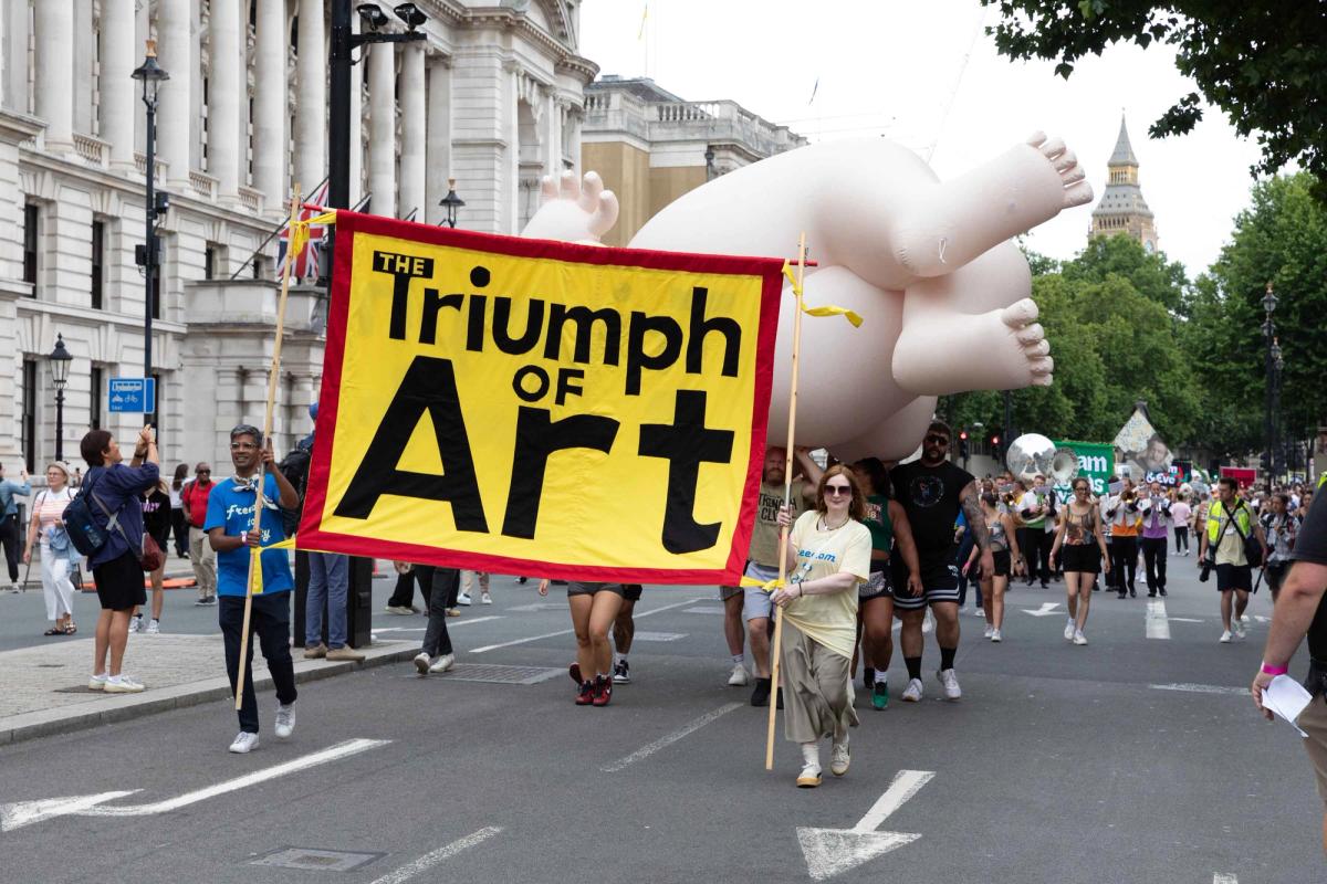 The Triumph of Art parade makes its way towards Trafalgar Square, with an inflatable resembling a figure from a Beryl Cook painting towards the front

Photo: David Owens
