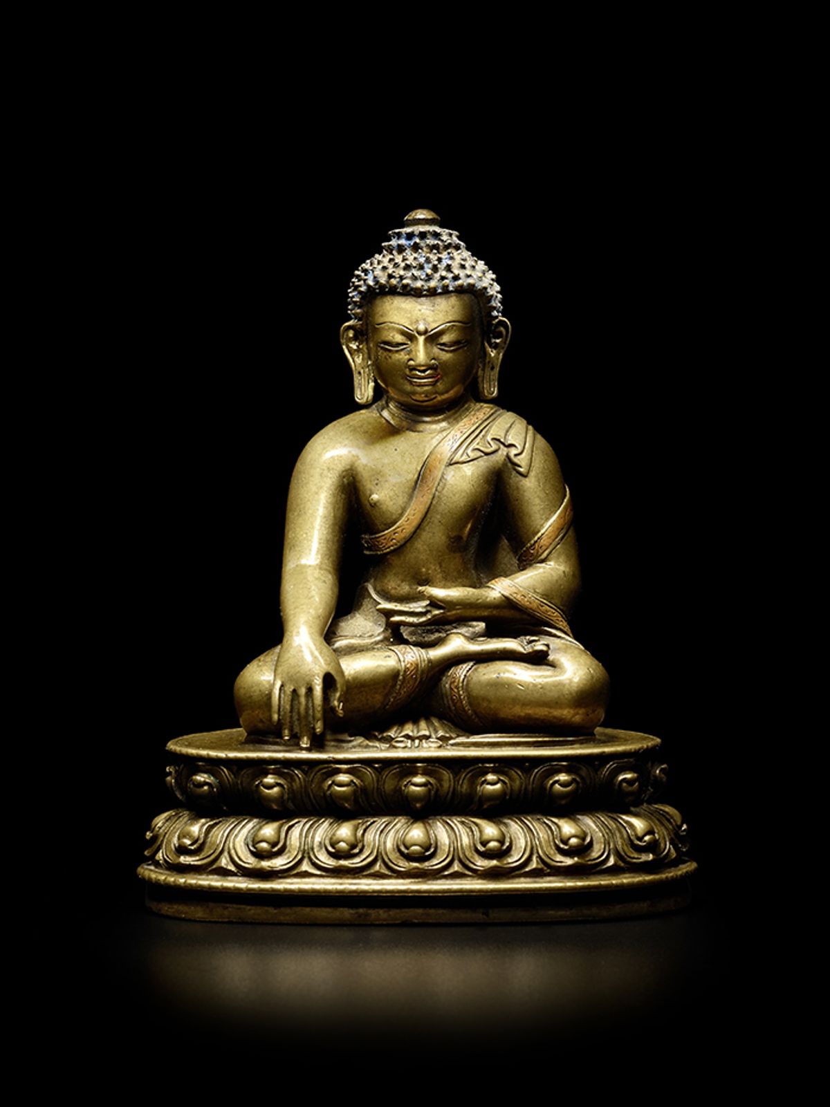 A copper inlaid brass alloy figure of Buddha Bonhams