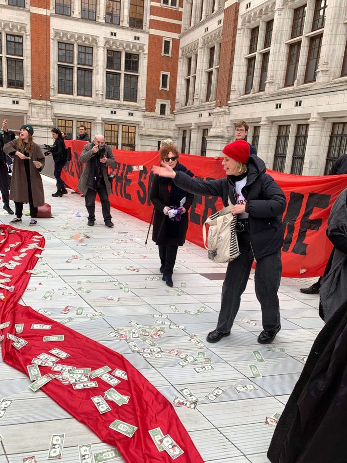 Pain protestors throw dollar signs over the Sackler courtyard at the V&A Gareth Harris