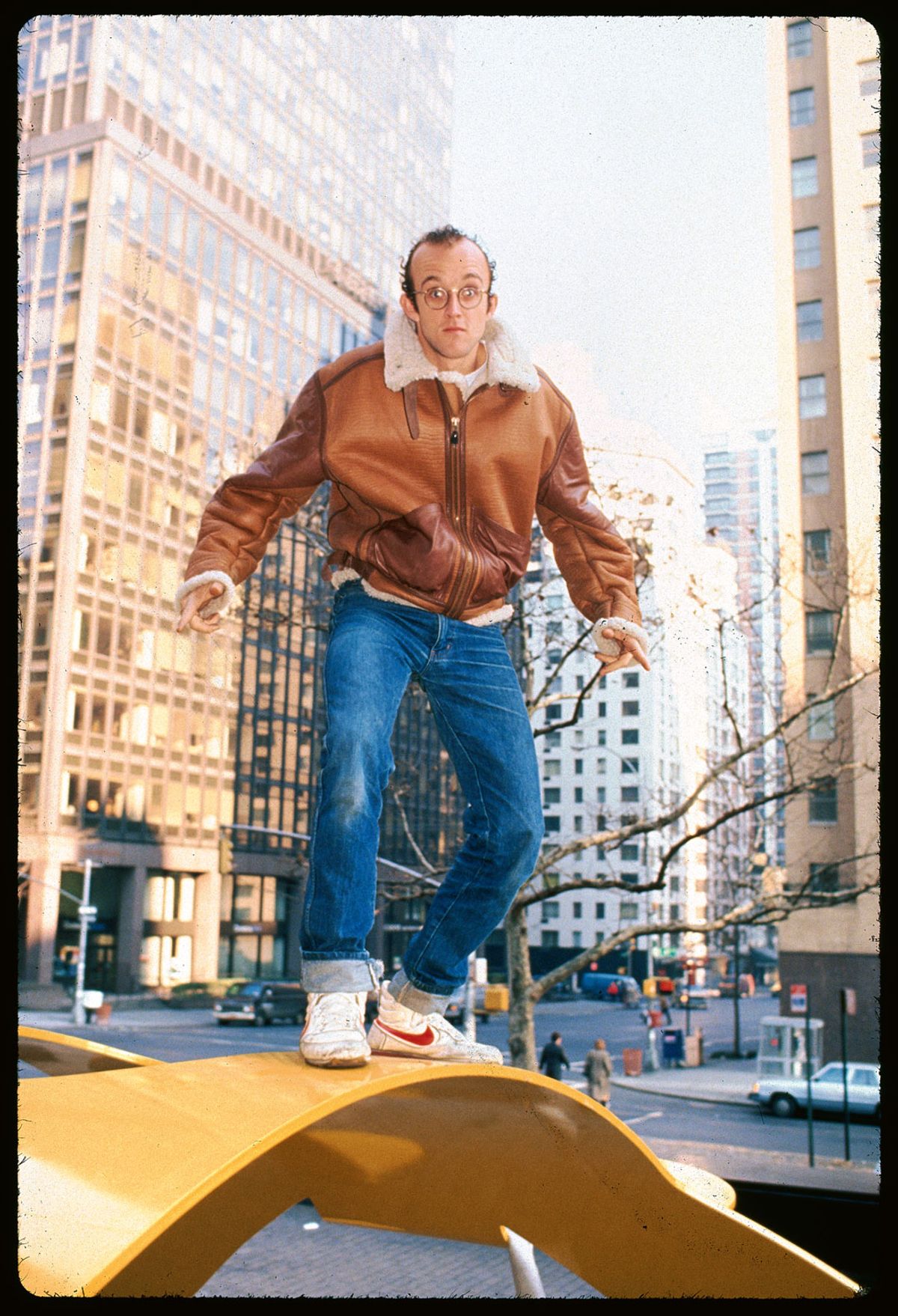Keith Haring on top of one of his sculptures © Getty