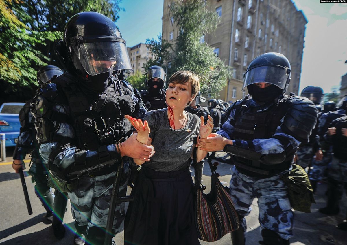 Alexsandra Parushina, an artist and district legislator, is led away from a protest after being beaten by riot police © Anton Sergienko
