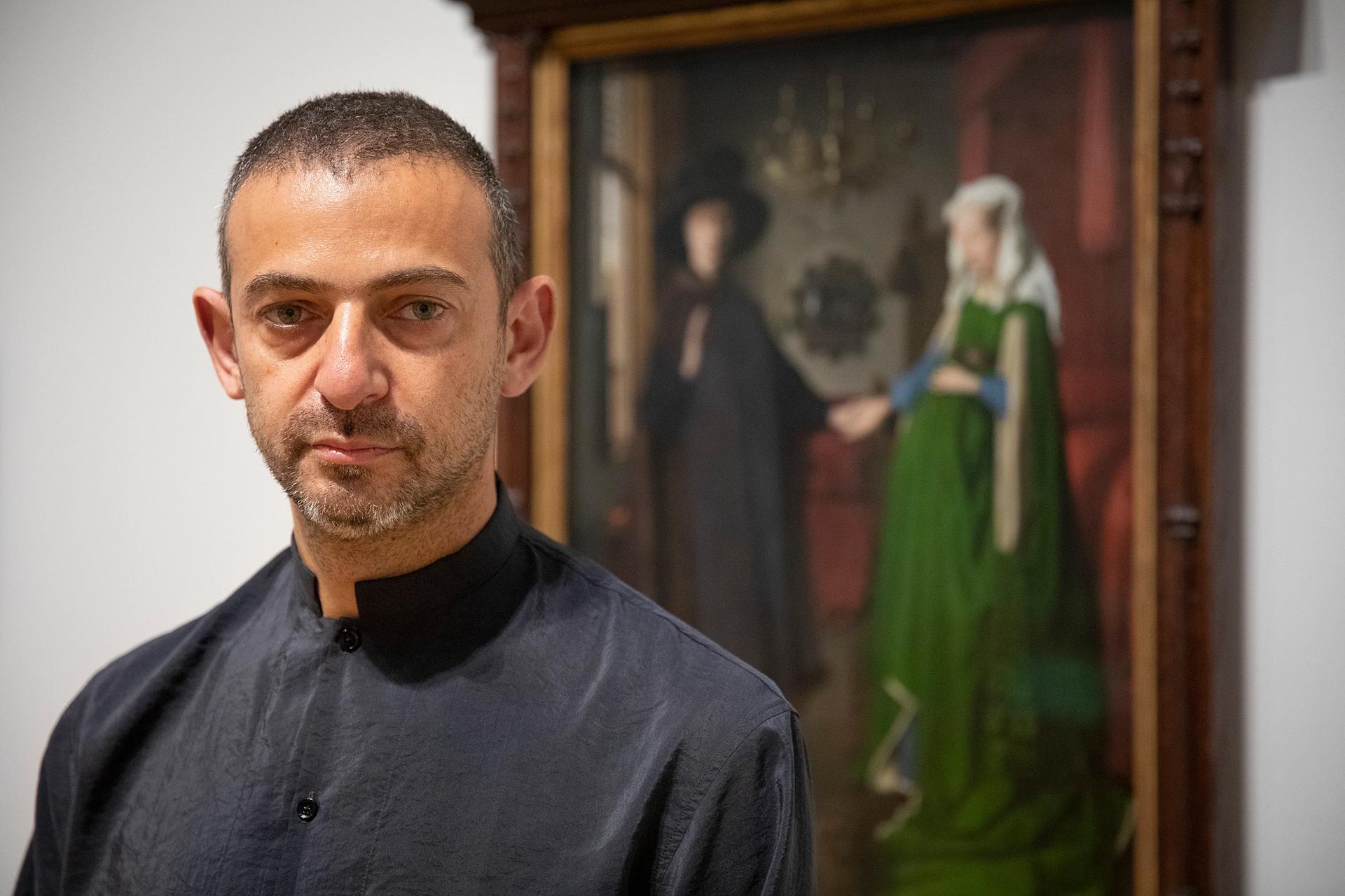 Ali Cherri in front of Van Eyck’s The Arnolfini Portrait at the National Gallery. © Photo: The National Gallery, London