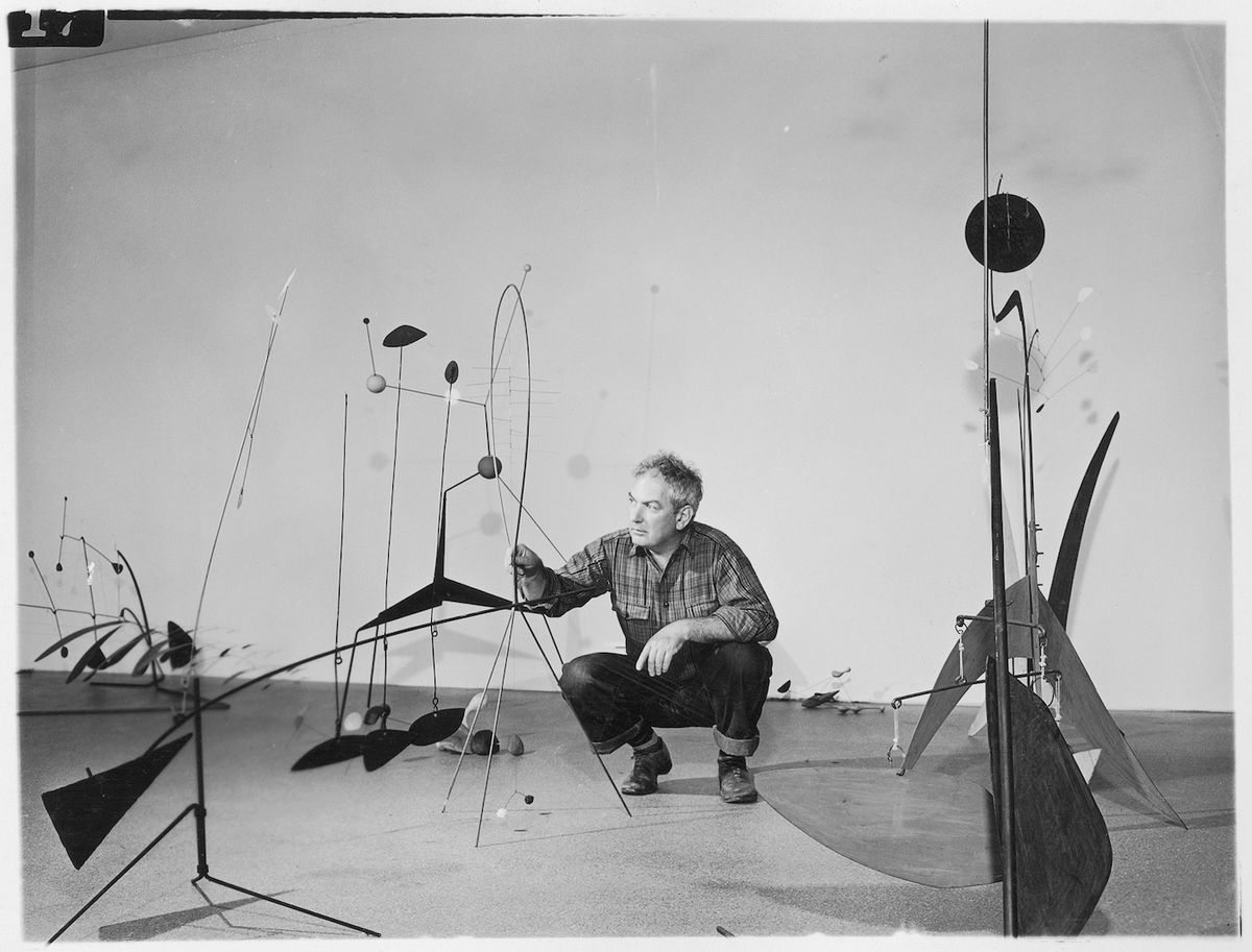 Publicity photograph of Calder during the installation of “Alexander Calder” in 1943 at the Museum of Modern Art Photographic Archive, The Museum of Modern Art Archives, New York. © 2021 Calder Foundation, New York / Artists Rights Society (ARS), New York
