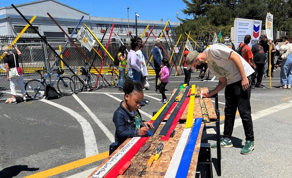 Community participants write on Fencelines colorful slats before their removal by Chevron Graham LP