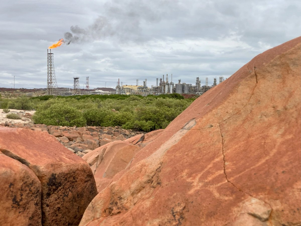 A turtle petroglyph with the North West Shelf project in the background © Save our Songlines
