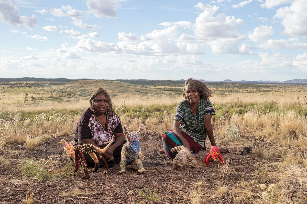 The artists Roma Butler and Yangi Yangi Fox from Irrunytju, a small Aboriginal community in Western Australia, with their sculptures, pictured here in 2017 Irrunytju artists © Rhett Hammerton