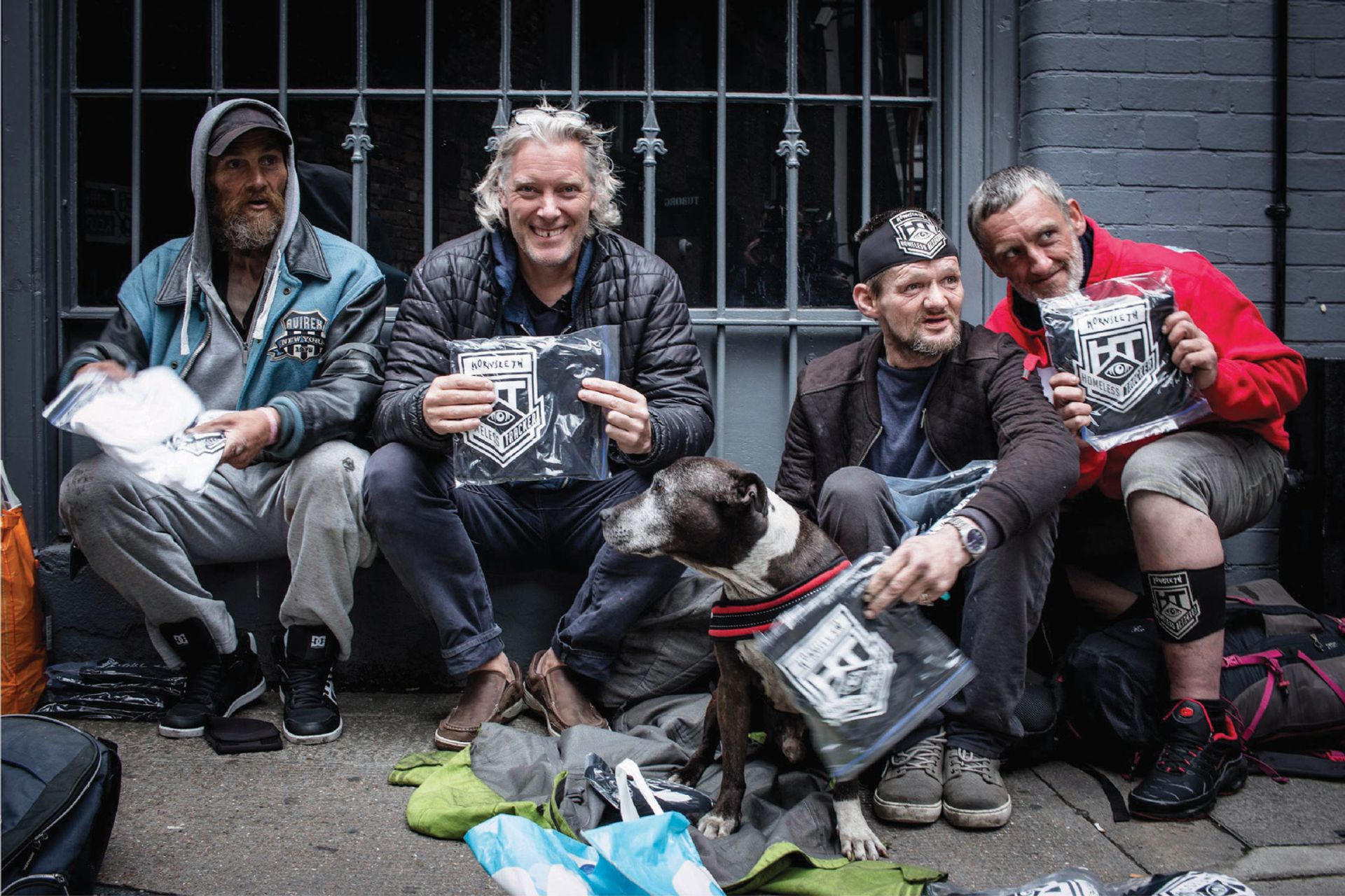 Homeless Londoners were fitted with tracking devices by Kristian von Hornsleth (second left) before being “followed” by art collectors © Arko Hojholt