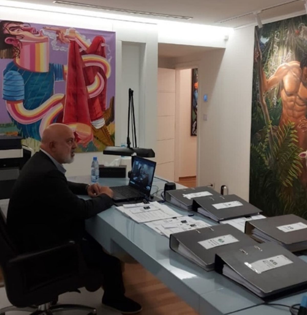 Nazem Ahmad in his office with art he allegedly commissioned US Department of Justice