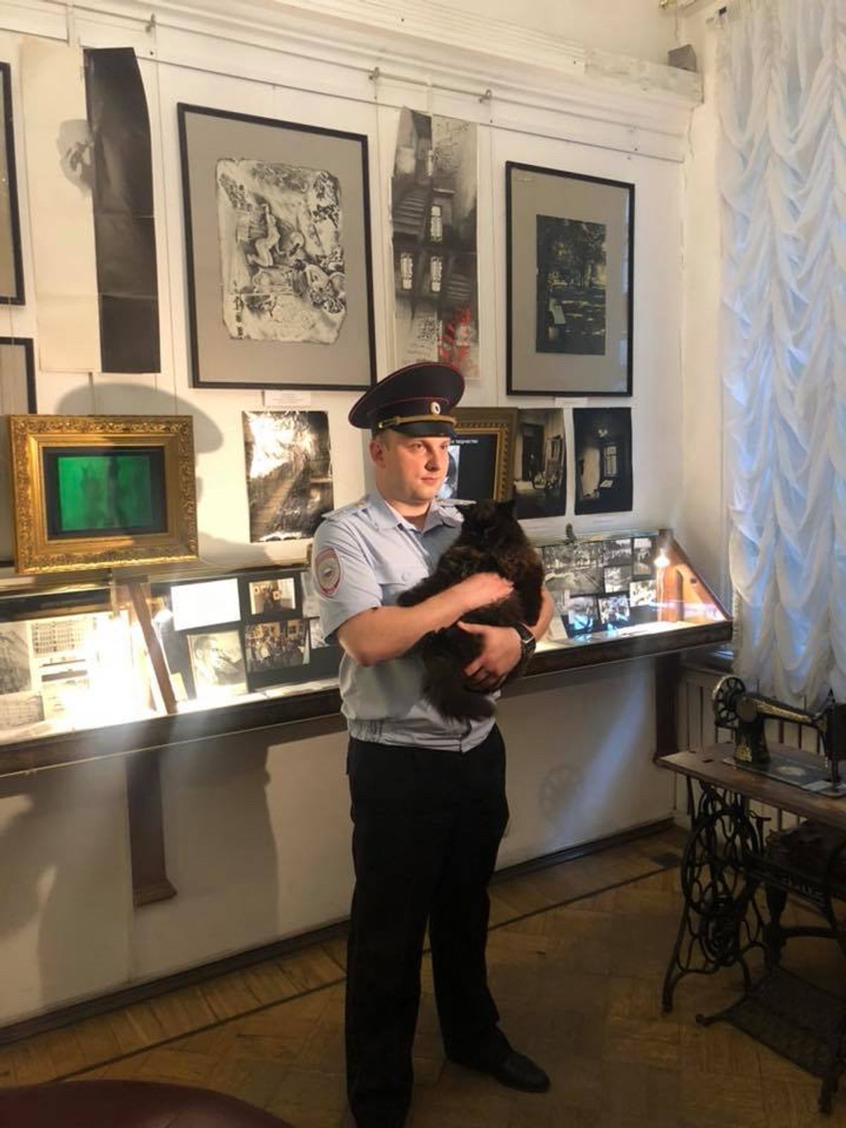 A Russian policeman carries Begemot courtesy Bulgakov Museum