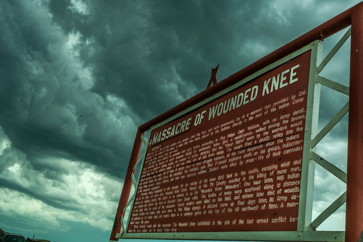 A sign on of the Oglala Sioux Pine Ridge Reservation commemorating the Wounded Knee Massacre in 1890 Photo by Adam Singer, via Flickr