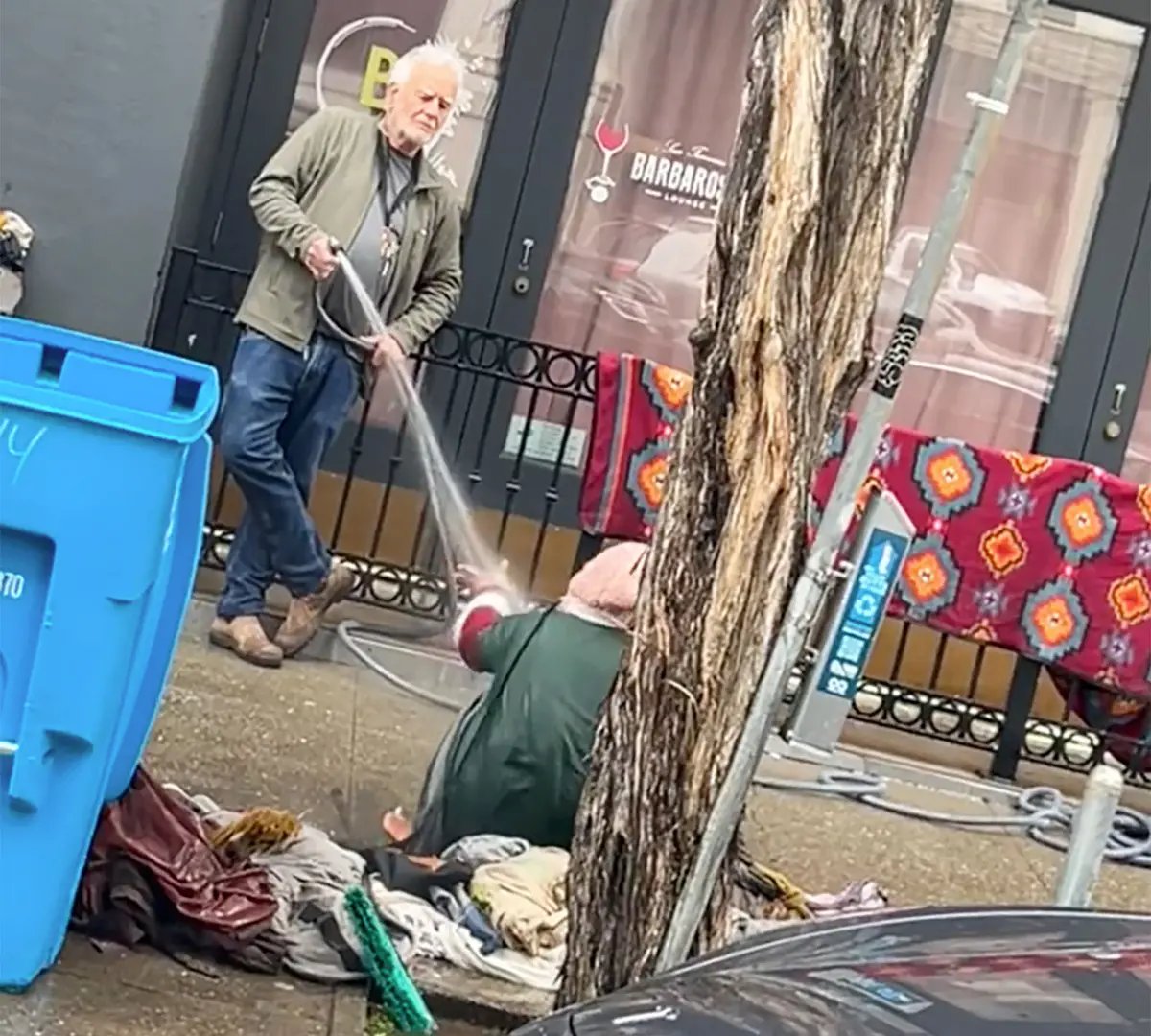 A video of San Francisco gallerist Collier Gwin spraying a woman outside of his gallery with a hose went viral earlier this year. Screenshot via Twitter