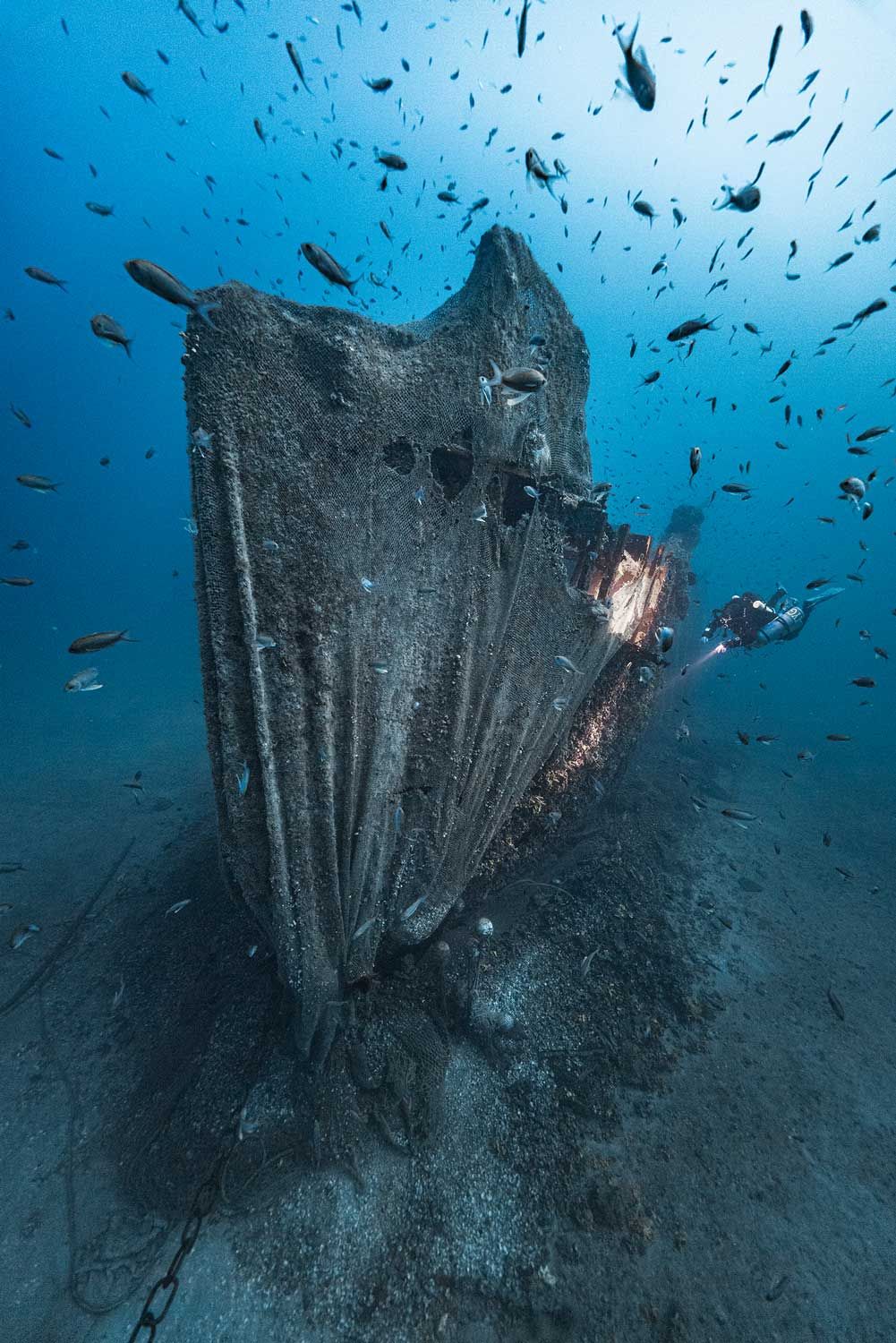 A diver is dwarfed by the wreck of a minesweeper off the coast of Gallipoli. The identity of the vessel, one of more than a hundred wrecks in the area, is unknown Photo: Martin Stmiska