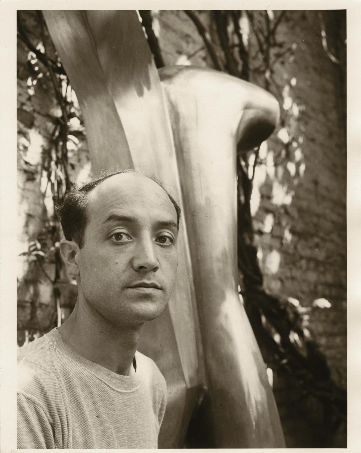 Isamu Noguchi in the courtyard of his MacDougal alley studio with Man Aviator (1943-49) © The Isamu Noguchi Foundation and Garden Museum, New York/ARS. Photo by Gina Hohensee