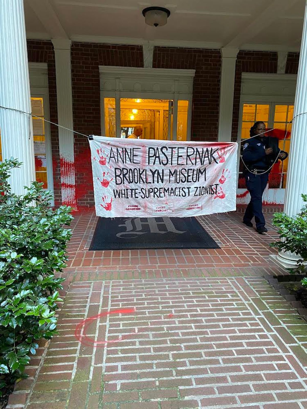The exterior of Anne Pasternak's apartment building in Brooklyn Heights, where activists hung a banner and splashed red paint on the evening of 11 June Photo by New York city council member Lincoln Restler, via X