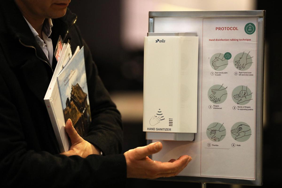 The Maastricht fair, which shut four days early due to a coronavirus outbreak, had stationed hand sanitiser dispensers throughout the venue © Oliver Berg/dpa/Alamy Live News