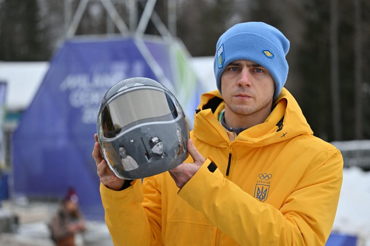 Vladyslav Heraskevych with his helmet, featuring portraits of 21 athletes killed in the conflict with Russia
Photo: Robert Michael/dpa