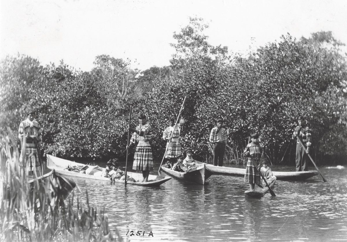 Seminole family outing, 1921: For thousands of years, people living in the area have used long dugout canoes to navigate the shallow waters of the Everglades Courtesy of HistoryMiami Museum