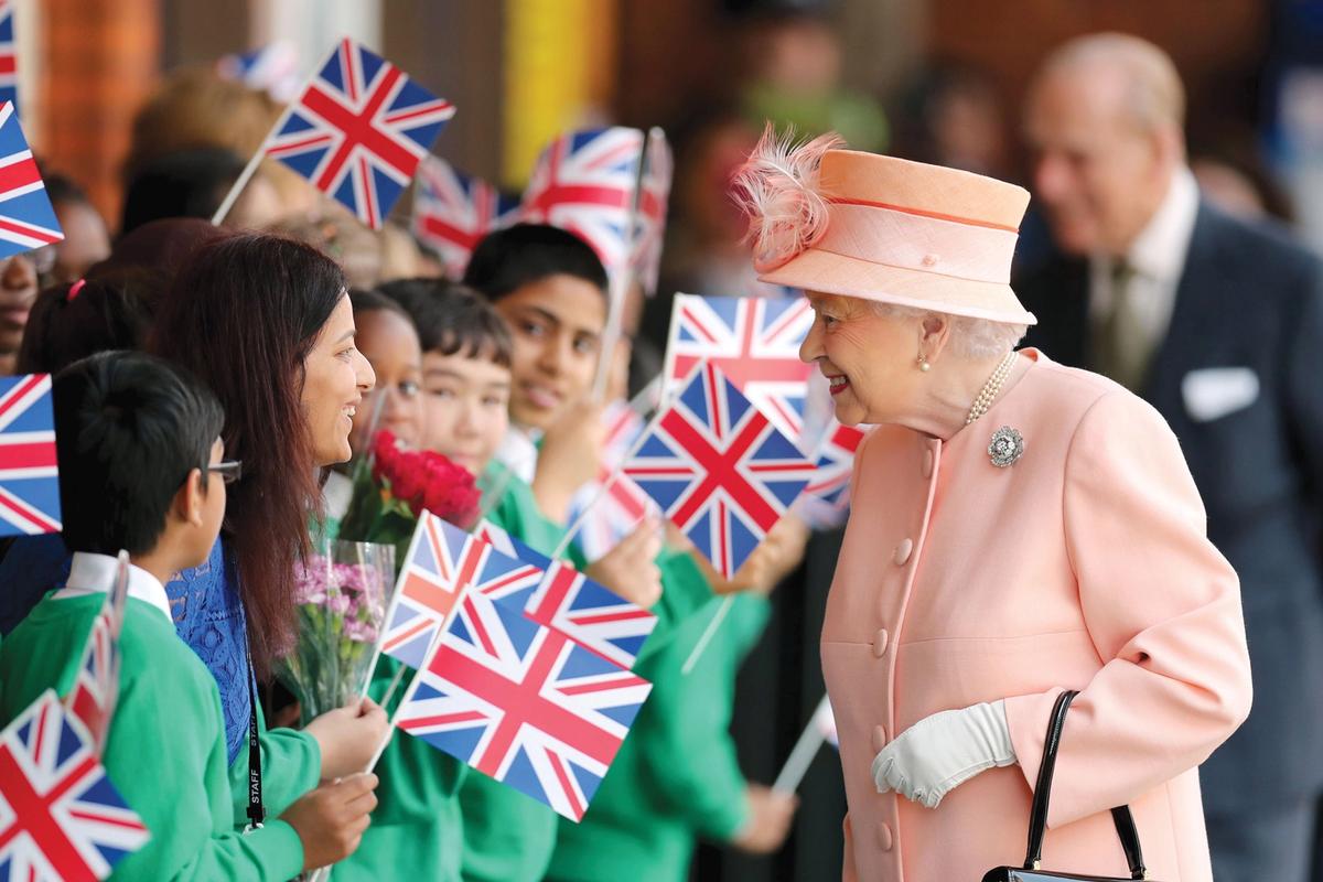 The artist is present: Queen Elizabeth II greeting people at Slough train station in 2017 Chris Radburn/Alamy Stock Photo