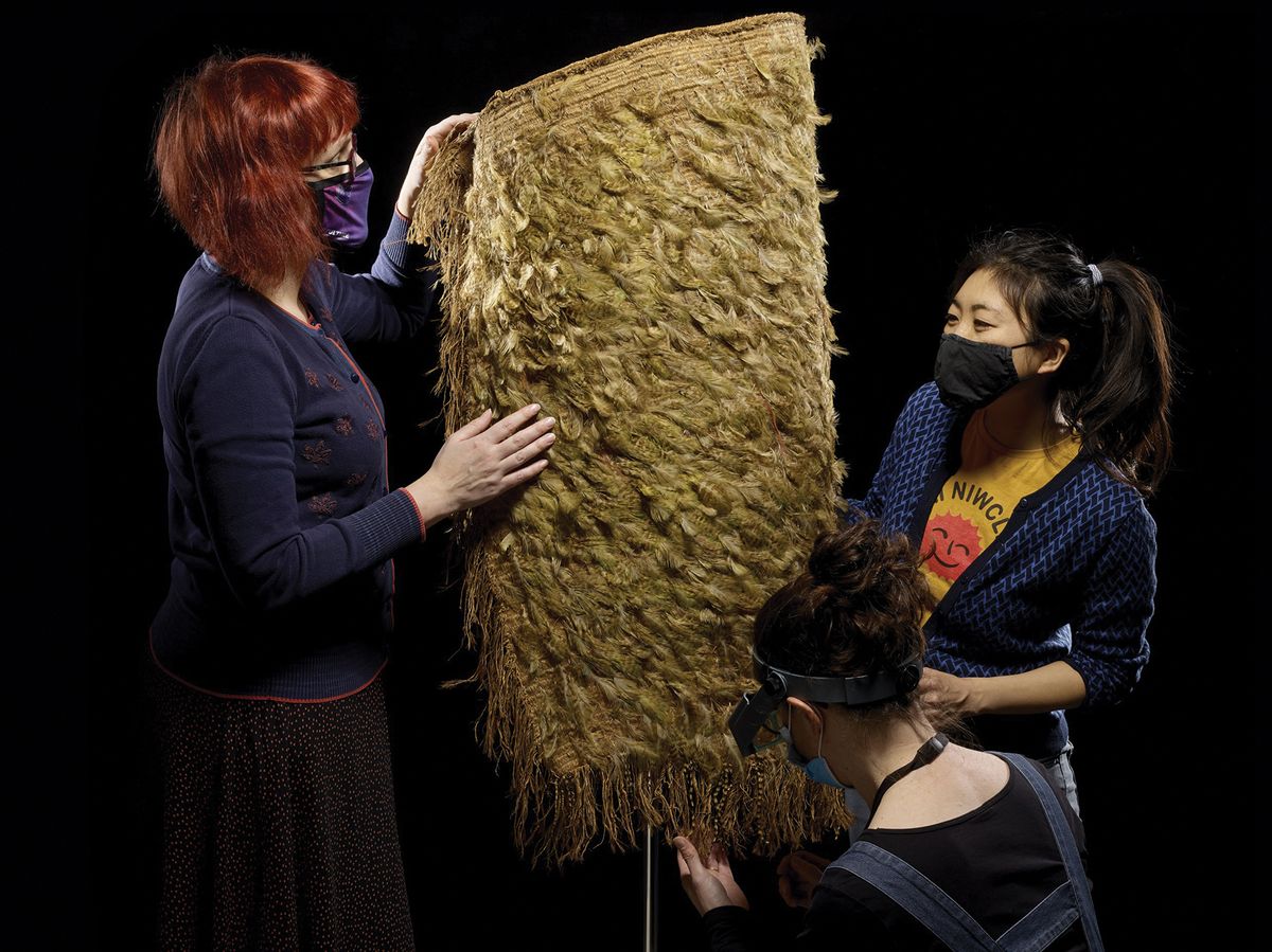 Conservators from the Perth Museum and the British Museum with the cloak, which is in a remarkable condition considering its age © Trustees of the British Museum and Culture Perth and Kinross