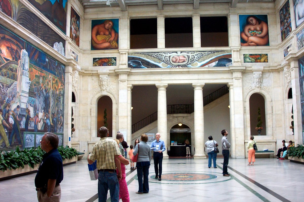 A gallery at the Detroit Institute of Arts featuring frescoes by Diego Rivera