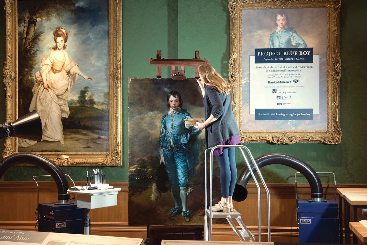 Conservator Christina O’Connell at work on The Blue Boy in one of the Huntington’s galleries—more than 200,000 visitors witnessed the conservation in progress in 2018-19 Courtesy of The Huntington Library, Art Museum and Botanical Gardens