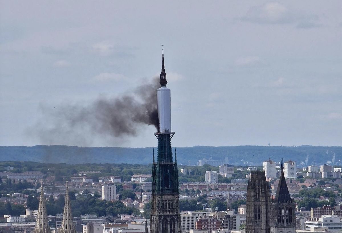 Smoke billows from the spire of Rouen cathedral in northern France. A section of plastic sheeting covering renovation work on the spire caught fire, the Guardian reported, though officials have not yet said said how the blaze began. Patrick Streiff/AFB via Getty Images