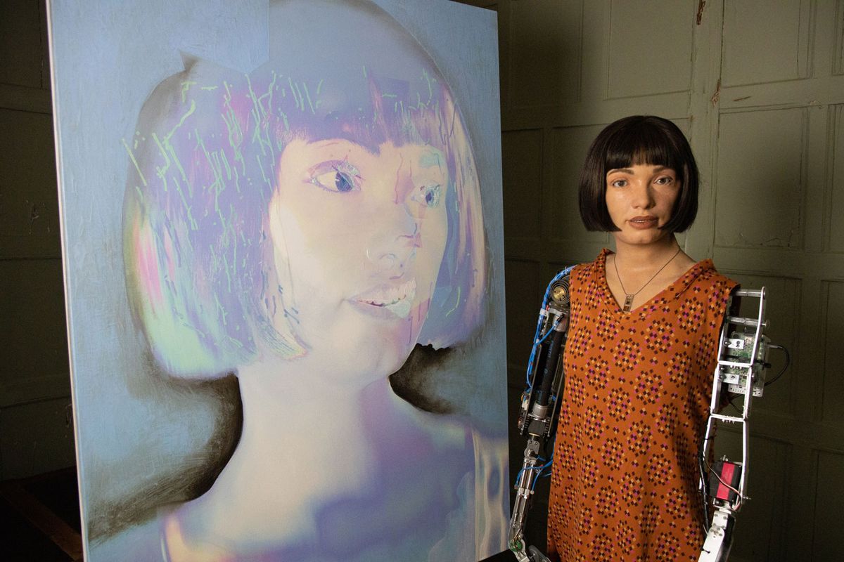 Ai-Da alongside its—or should that be “her”?—self portrait 